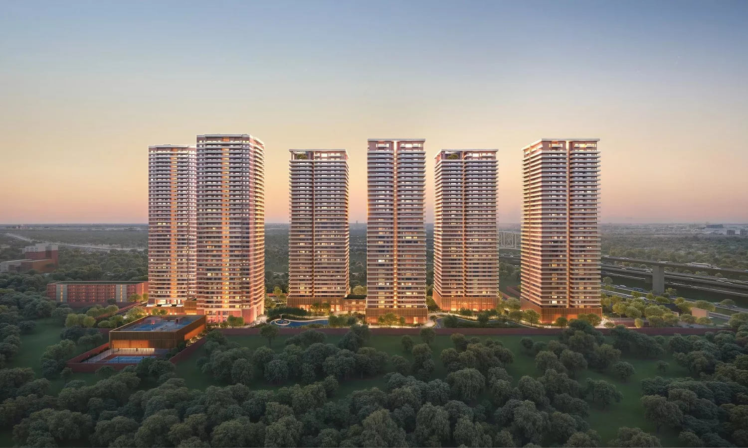 Aerial view of MAX Estates 360 premium high-rise residential towers with landscaped greens and modern architecture at dusk
