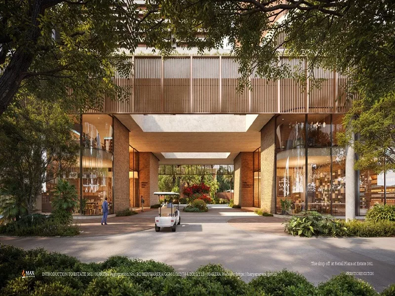 Grand entrance lobby and retail plaza at Max Estates 361 premium residential project with landscaped surroundings, modern glass facade, and spacious drive.