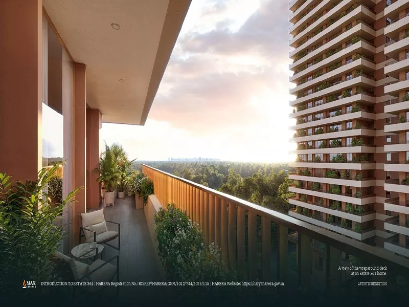 Spacious balcony view at Max Estates 361 residential project featuring modern high-rise tower, lush green surroundings, and sunset skyline view.